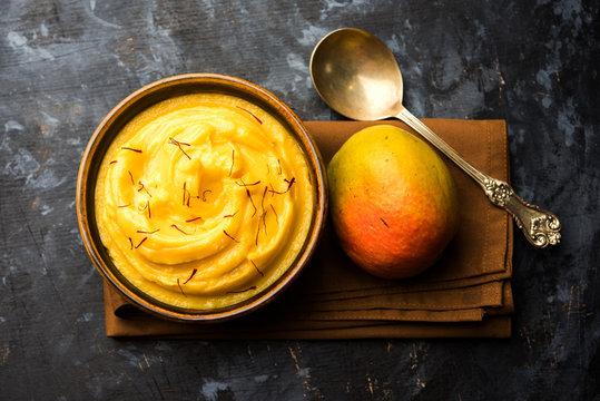 Amrakhand OR Mango Shrikhand / srikhand is popular Indian dessert served with saffron toppings in a bowl
