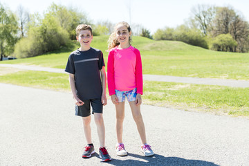 Girl and boy running, outside and having fun