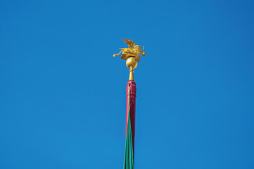 Fototapeta na wymiar Close-up of the golden winged lion, symbol of Venice, on top of a pole in Piazza San Marco. At the city of Venice, the historic and amazing marine city. Located in Veneto region, northern Italy