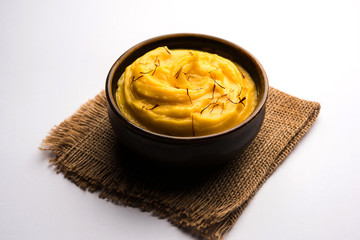 Amrakhand OR Mango Shrikhand / srikhand is popular Indian dessert served with saffron toppings in a bowl
