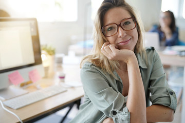 Beautiful woman working on desktop computer, co-working area