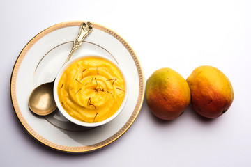 Amrakhand OR Mango Shrikhand / srikhand is popular Indian dessert served with saffron toppings in a bowl