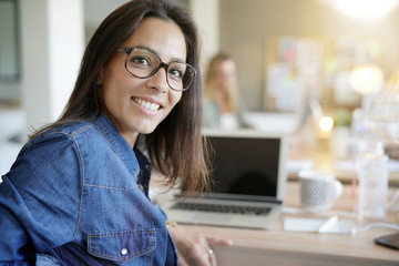 Cheerful girl working in co-working office