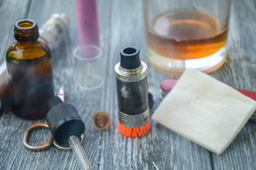 Still life with e-cig and jiuce on the wooden background