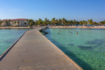 Wooden pier in Higgs Beach, a popular Key West beach in Florida known for snorkeling, tropical...