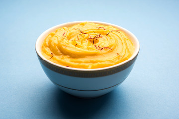 Amrakhand OR Mango Shrikhand / srikhand is popular Indian dessert served with saffron toppings in a bowl