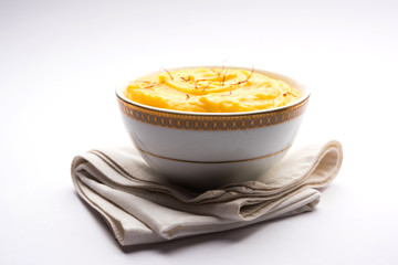 Amrakhand OR Mango Shrikhand / srikhand is popular Indian dessert served with saffron toppings in a bowl