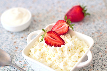 Tasty food. A dish of fresh strawberries and cottage cheese. Vitamin supplement. Dietary and vegetarian product. Add healthy and nutritious food to your diet.