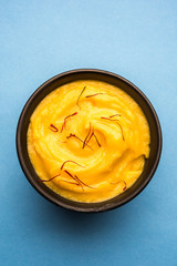 Amrakhand OR Mango Shrikhand / srikhand is popular Indian dessert served with saffron toppings in a bowl