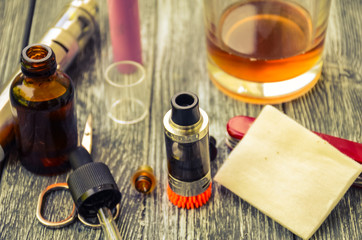 Still life with e-cig and jiuce on the wooden background