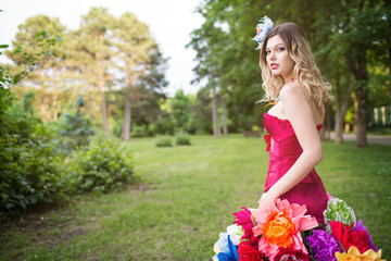 Young woman in an unusual skirt of flowers