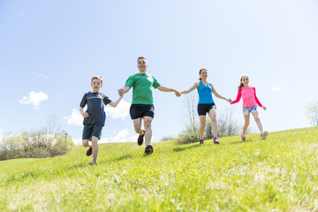Fototapeta premium Parents with children sport running together outside