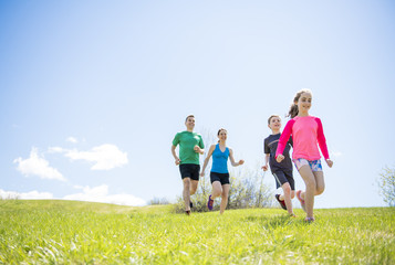 Parents with children sport running together outside