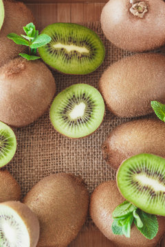 Green kiwis and mint leaves, top view