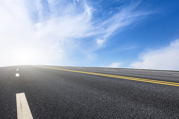 Naklejka premium new asphalt road and sky clouds