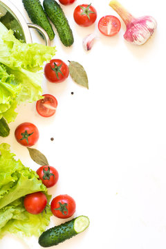Healthy fresh vegetables for salad. Raw green lettuce, greens, tomato over white countertop. Top view. Copy space. Clean eating, detox. Food concept.