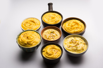 Shrikhand & Amrakhand served in different size bowl in group. Selective focus