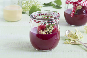 Fruit dessert in glass with fresh raspberries