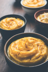 Shrikhand & Amrakhand served in different size bowl in group. Selective focus
