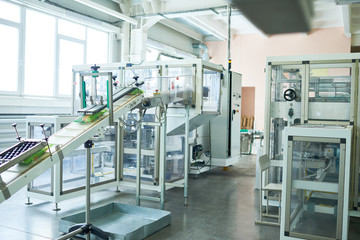 Interior of production workshop at food factory, modern assembly line units for packaging, copy...