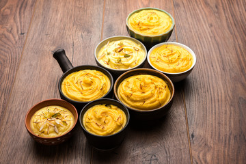 Shrikhand & Amrakhand served in different size bowl in group. Selective focus