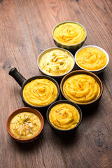 Shrikhand & Amrakhand served in different size bowl in group. Selective focus