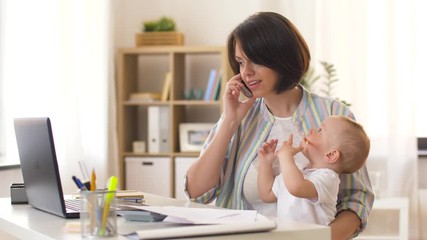 multi-tasking, freelance and motherhood concept - working mother with baby boy at home office calling on smartphone