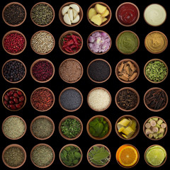 set of spices in wooden cups isolated on black background, spices background. top view