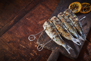 Grilled fish on skewers with copy space