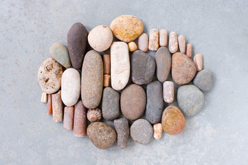 Shape of various stones on the textured grey background