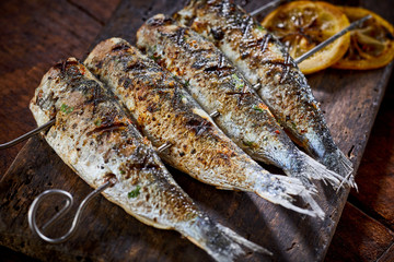 Four spicy grilled fresh fish on skewers