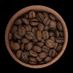 coffee in wooden cup isolated on black. top view