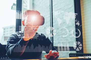 Business man using Virtual Reality simulator headset and developing a new project