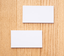 Two business cards on a wooden background background