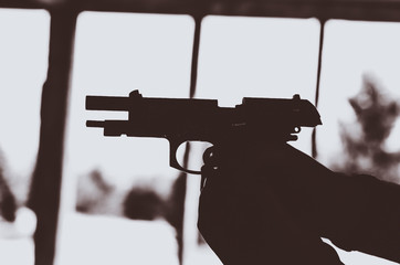 Blured airsoft gas hand gun out of ammo Black and white