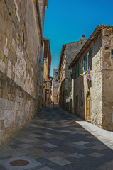 View of narrow alley with old buildings and belfry in Colle di Val d Elsa. A graceful village with its historic center preserved and known by its crystal production. Located in the Tuscany region 