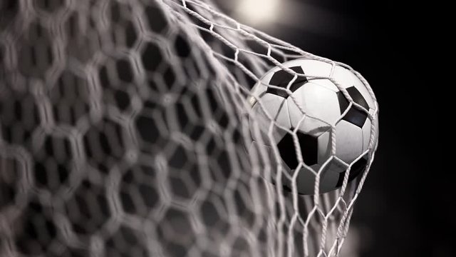 Beautiful soccer ball flies into net of gate. The movement at the beginning is accelerated then slowly