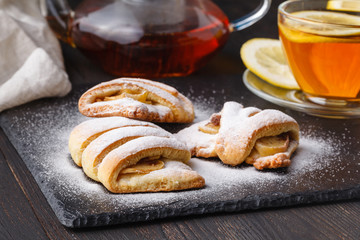 Tea and freshly baked cottage cheese apple cookies garnished with sugar