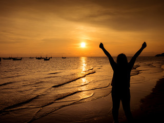 Fototapeta na wymiar Girl cheerful background sunset at the sea