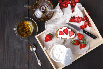 Fototapeta na wymiar Sandwich with strawberries, cheese and tea cup