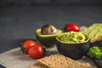 Mexican cold appetizer made of pureed avocado pulp with bread and vegetables. Concept healthy vegetarian Breakfast