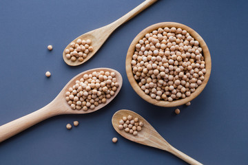dry raw chickpeas in wooden bowl and spoons
