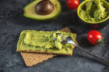Mexican cold appetizer made of pureed avocado pulp with bread and vegetables. Concept healthy vegetarian Breakfast