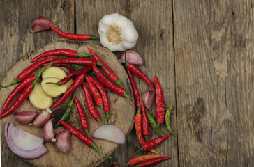 spices and vegetables on wooden background