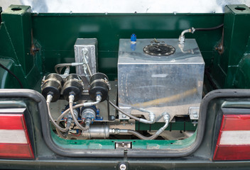 Handmade nitrous oxide engine in car trunk.