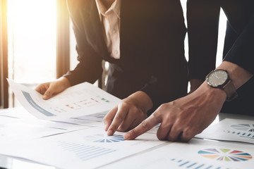 Business people using pen,tablet,notebook are planning a marketing plan to improve the quality of their sales in the future.