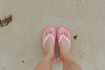 Fototapeta na wymiar Woman's feet on the beach.