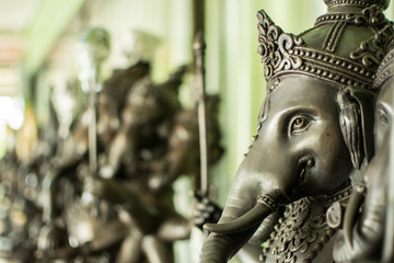 Close up black Ganesha statue and gray texture ganesh is hindu god of Success