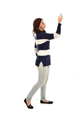  full length portrait of girl wearing striped blue and white jumper and jeans. standing pose on white studio background