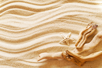 Fototapeta na wymiar Starfish on sea sand, top view, copy space. Sea background. Beach rest